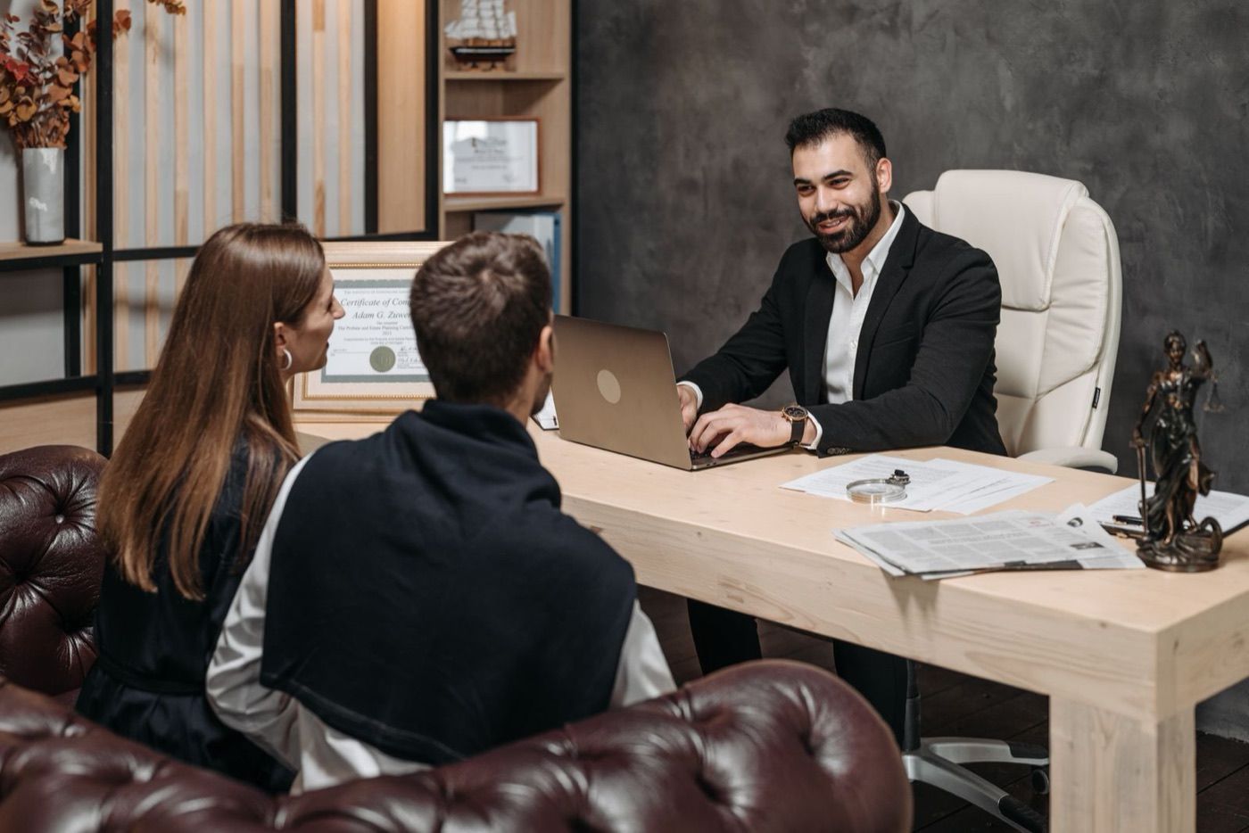 A family lawyer meeting with a couple in his office
