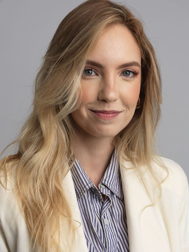 Hannah Brooks, a young woman with long blonde hair in a cream blazer