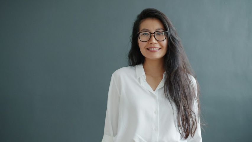 Mei Park, a woman with long dark hair and glasses, in a white blouse